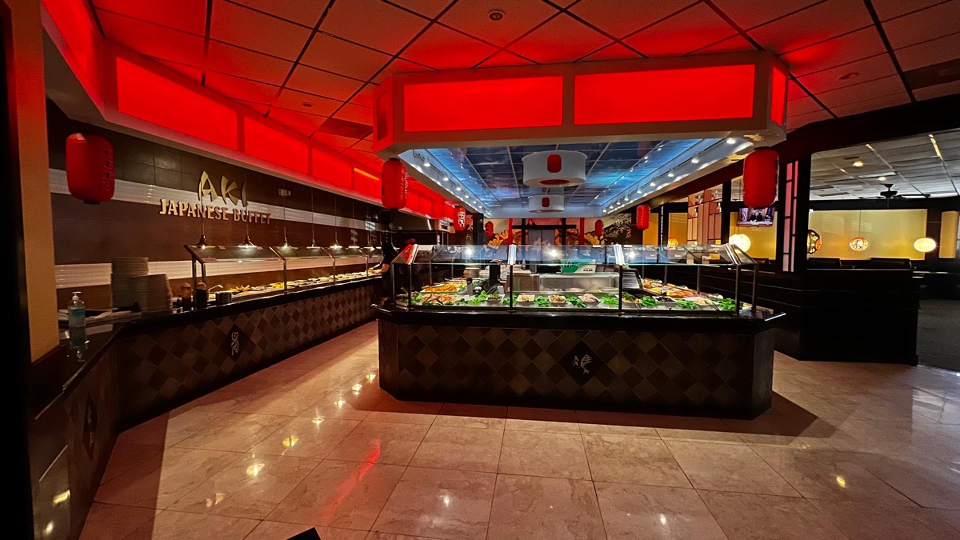 Aki Japanese Buffet interior with red-lit buffet stations